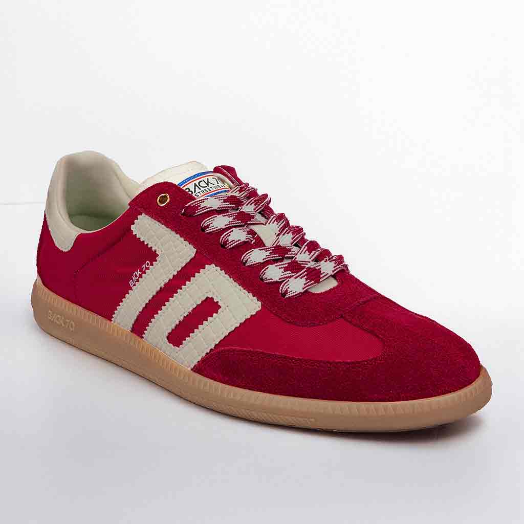 Red sneaker with white accents on a light gray background